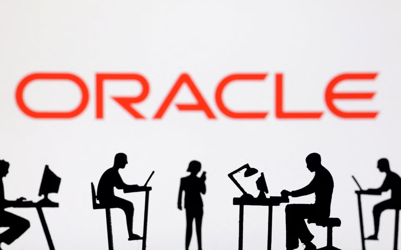 带有电脑和智能手机的小人偶位于Oracle标志前